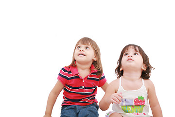 Image showing Two little girl looking up, two and four years old, isolated on 