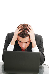 Image showing Young caucasian worried businessman with a laptop