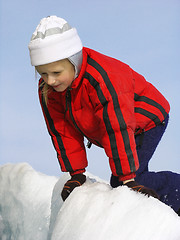 Image showing Young girl looking into the crack in the ice field