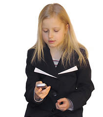 Image showing Young girl dialing phone number