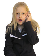 Image showing Young girl dialing phone number