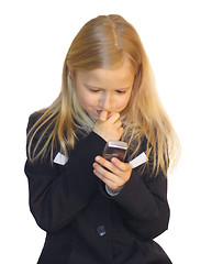 Image showing Young girl dialing phone number