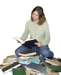 Image showing Student girl reading on the heap of books