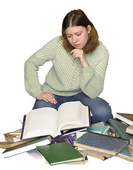 Image showing Student girl reading on the heap of books