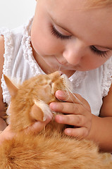 Image showing child playing with a kitten