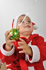 Image showing Santa baby playing with a Christmas ball