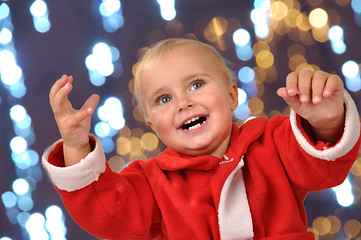 Image showing happy Christmas baby with hands raised