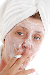 Image showing woman with towel on her head smoking