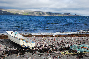 Image showing Lonaly boat at Barebtz sea cost close to abandoned fishing villa