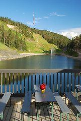 Image showing Vew at Ruka lake with fontain and hill from the terrase