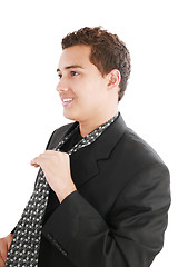 Image showing An young man fixing his tie 