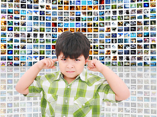 Image showing kid protecting ears from loud noise of so many screens talking