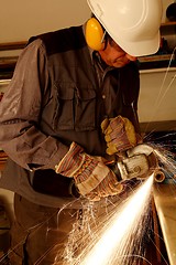 Image showing Worker with angle grinder