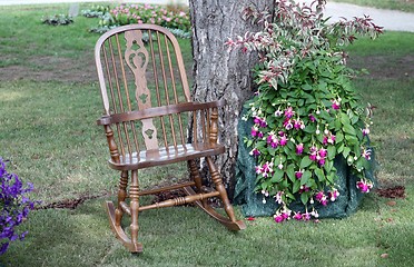 Image showing Rocking chair and flowers