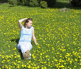 Image showing Girl on dandelion lawn