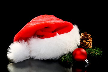Image showing Santa's hat, Christmas ball and pine cone.