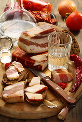 Image showing Glass of vodka, bacon on rye bread.
