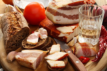 Image showing Glass of vodka bacon on rye bread. 
