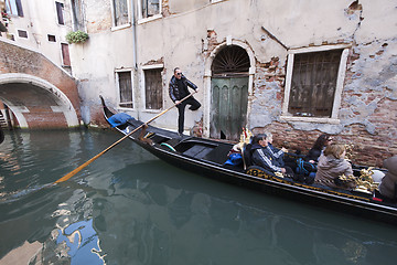 Image showing Gondolier in a narrow canal