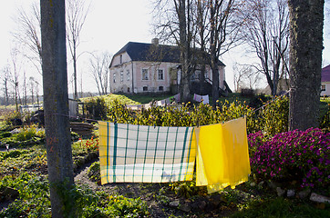 Image showing Old house with slate roof. Laundry drying on rope.