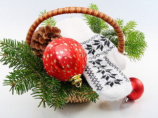 Image showing Basket with Christmas tree,balls and pine cones.