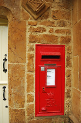 Image showing Red british post box on stone wall