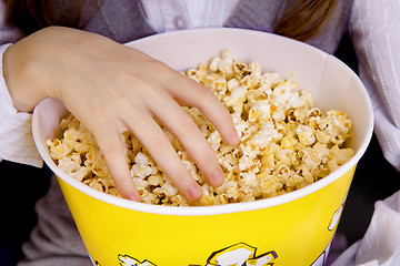 Image showing hand in a bucket of popcorn