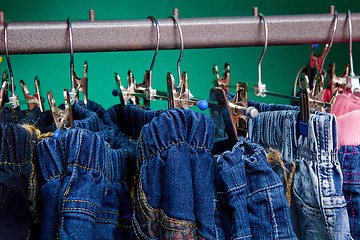 Image showing Denim pants on a hanger for children in the store