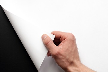 Image showing hand turning paper