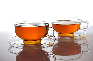 Image showing cup of tea on white with reflection