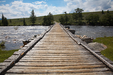 Image showing Wooden bridge over river