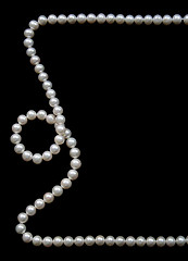 Image showing White pearls on the black velvet  background