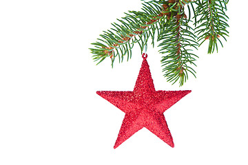 Image showing red christmas star hanging from tree