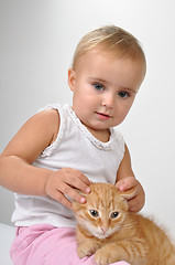 Image showing baby playing with a kitten