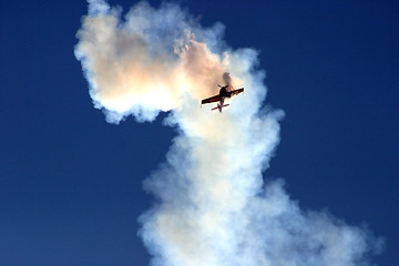 Image showing Plane in the cloud of smoke at the European Aerobatic Championship. Highly contrasted and toned, seems like a plane crash.