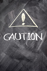 Image showing Caution written on blackboard