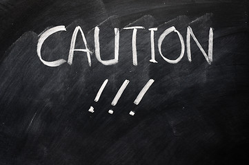 Image showing Caution written on blackboard