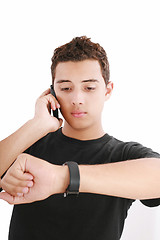 Image showing Portrait of a busy young male using mobile phone and looking at 