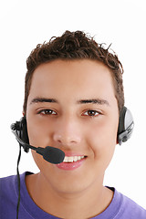 Image showing Smiling young man with telephone headset isolated on white backg