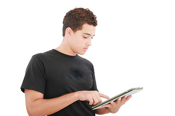 Image showing Young casual student working on a digital tablet. Isolated on a 