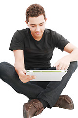 Image showing Young man using a touch pad PC, isolated on white