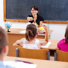 Image showing Teacher pointing at schoolgirl