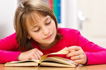 Image showing Schoolgirl reading in classroom