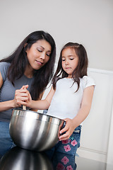 Image showing Mother and daughter in kitchen baking