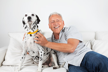 Image showing Senior Man Sitting With His Dog