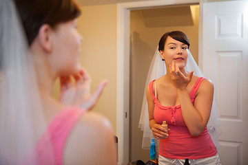 Image showing Bride Applying Make up