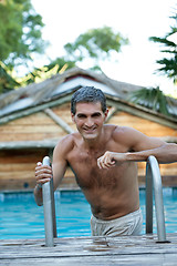 Image showing Smiling Middle Aged Man Standing in Pool