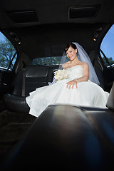 Image showing Bride With Flower Bouquet in Limo