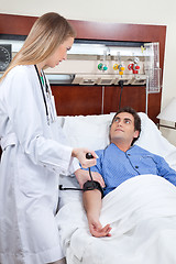 Image showing Doctor checking the blood pressure of patient