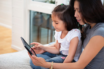 Image showing Mother and daughter reading electronic book